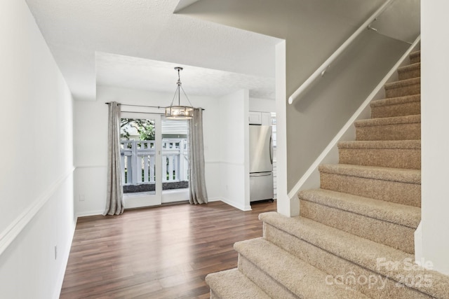 8510 Castle Pine Ct, Charlotte, NC 28226 - stairway with wood finished floors, baseboards, and a chandelier
