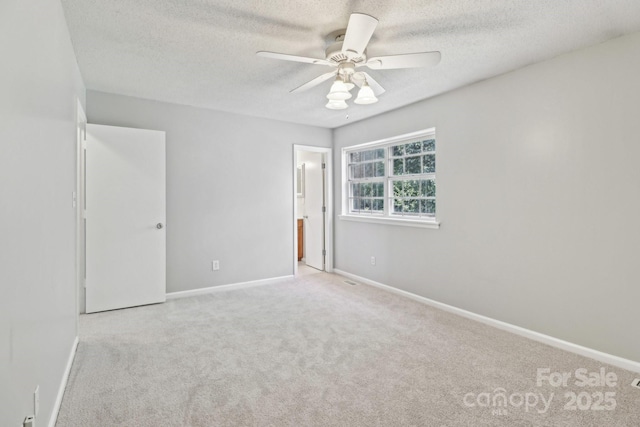 8510 Castle Pine Ct, Charlotte, NC 28226 - unfurnished bedroom featuring carpet flooring, baseboards, a textured ceiling, connected bathroom, and a ceiling fan