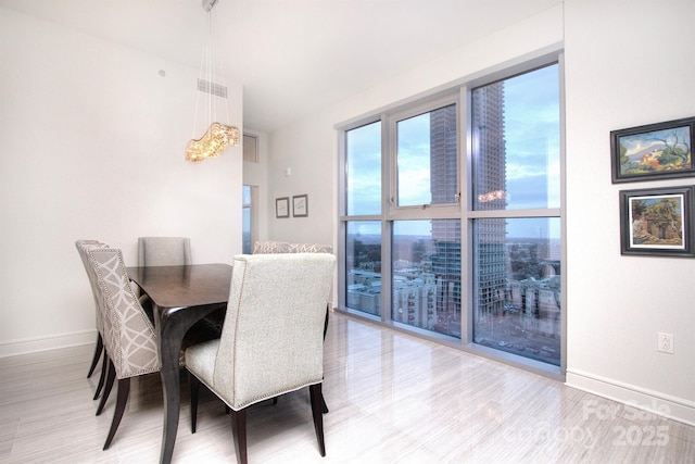 333 W Trade St Unit 1304, Charlotte, NC 28202 - dining area with wood finished floors and baseboards