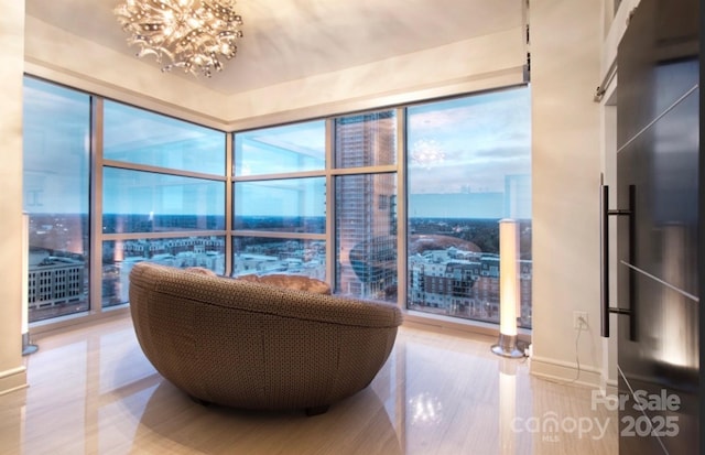 333 W Trade St Unit 1304, Charlotte, NC 28202 - living area with a city view, a chandelier, wood finished floors, and baseboards