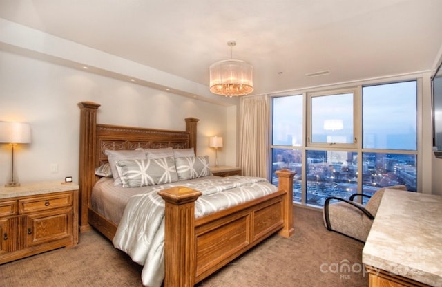 333 W Trade St Unit 1304, Charlotte, NC 28202 - bedroom featuring light carpet and a chandelier