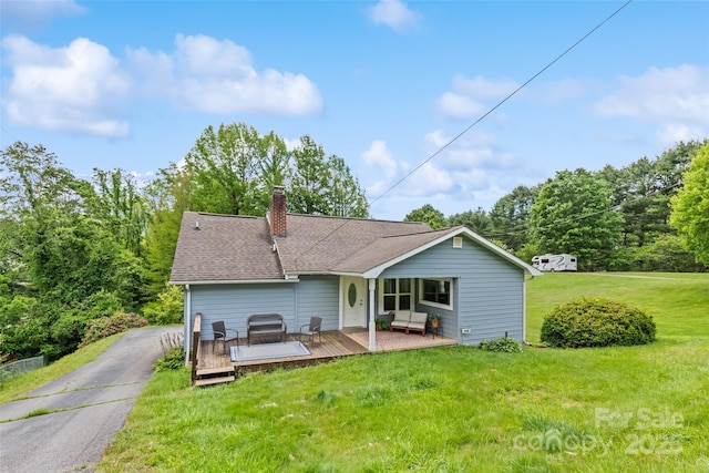 48 Medford Ave, Waynesville, NC 28786 - rear view of house featuring a yard, a deck, and a chimney