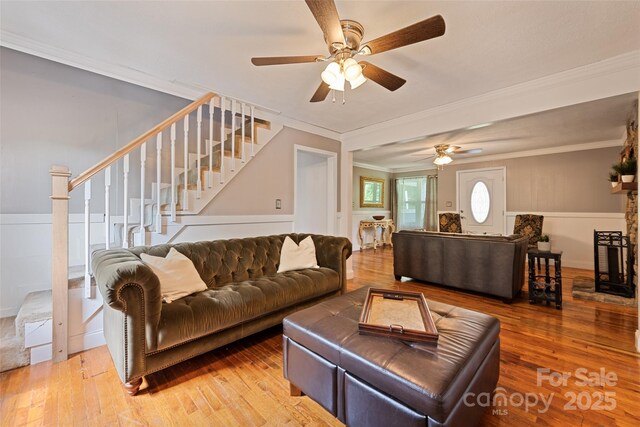 48 Medford Ave, Waynesville, NC 28786 - living area featuring stairs, ornamental molding, a ceiling fan, light wood finished floors, and wainscoting