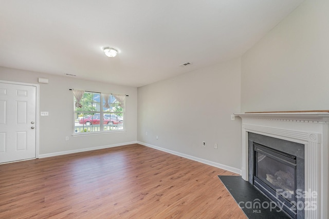 8524 Emerald Fern Way, Charlotte, NC 28214 - unfurnished living room with light wood-style flooring, a fireplace with flush hearth, and baseboards