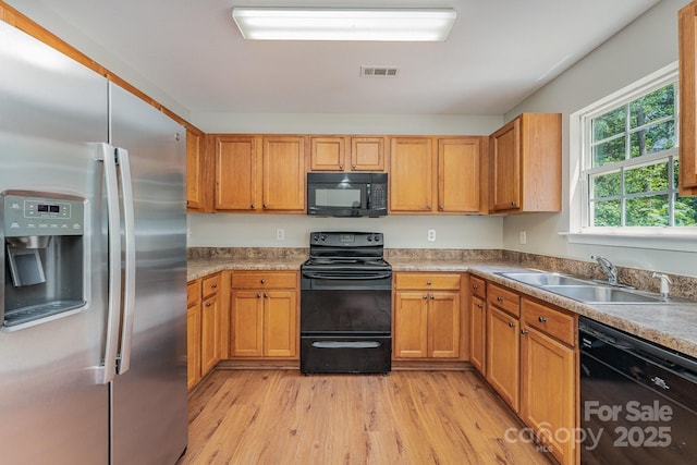 8524 Emerald Fern Way, Charlotte, NC 28214 - kitchen featuring black appliances, a sink, light wood finished floors, and light countertops