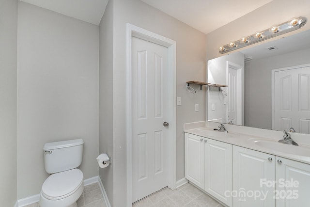 8524 Emerald Fern Way, Charlotte, NC 28214 - bathroom with double vanity, toilet, baseboards, and tile patterned flooring