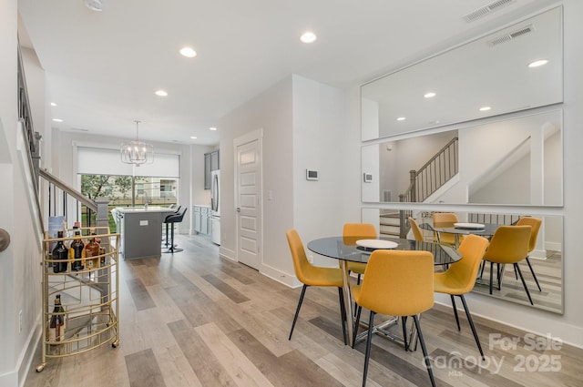 235 S Bruns Ave, Charlotte, NC 28208 - dining area featuring stairway, light wood-style floors, baseboards, and recessed lighting