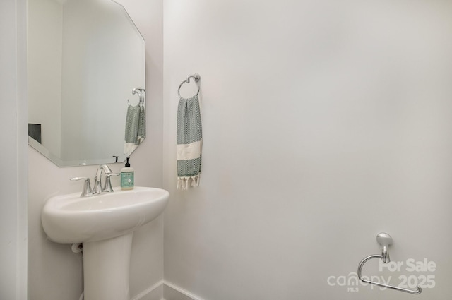 235 S Bruns Ave, Charlotte, NC 28208 - bathroom featuring baseboards and a sink