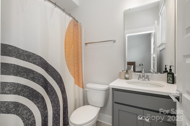 235 S Bruns Ave, Charlotte, NC 28208 - full bath featuring toilet, vanity, baseboards, and a shower with shower curtain