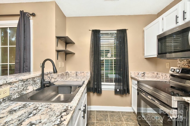 6401 Windsor Gate Ln, Charlotte, NC 28215 - kitchen featuring stainless steel appliances, a sink, baseboards, white cabinetry, and open shelves