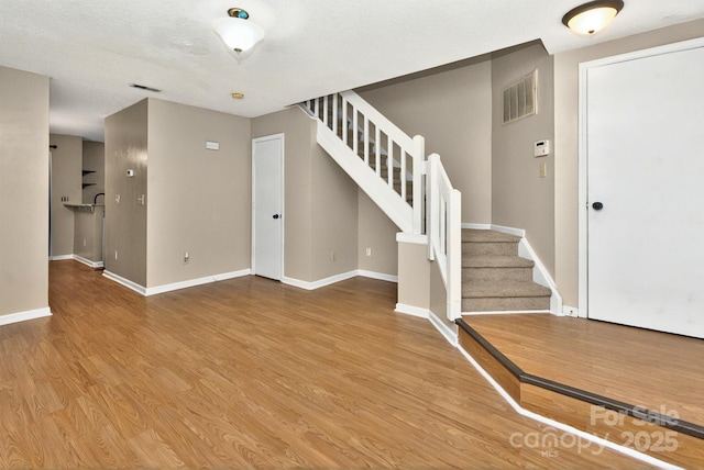 6401 Windsor Gate Ln, Charlotte, NC 28215 - foyer entrance featuring stairs, wood finished floors, and baseboards