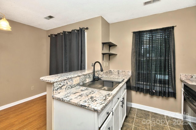 6401 Windsor Gate Ln, Charlotte, NC 28215 - kitchen featuring a sink, white cabinetry, open shelves, baseboards, and a peninsula