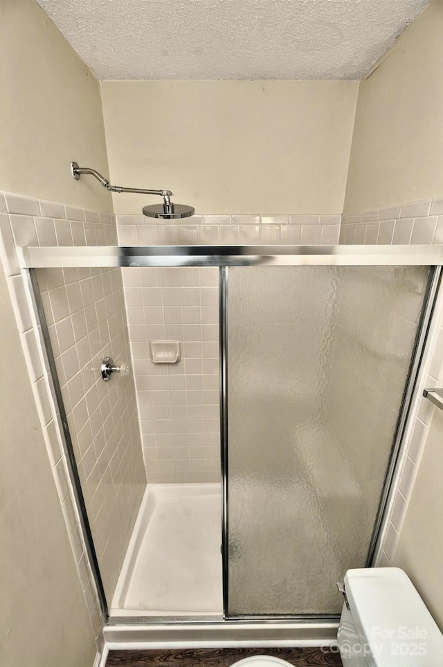 6401 Windsor Gate Ln, Charlotte, NC 28215 - bathroom featuring toilet, a shower stall, and a textured ceiling