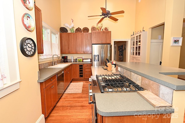 616 N Deal Ave, Newton, NC 28658 - kitchen with stainless steel appliances, a center island, a sink, a towering ceiling, and a ceiling fan