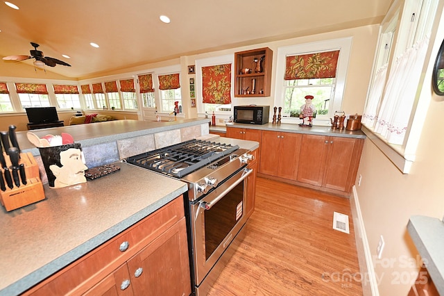 616 N Deal Ave, Newton, NC 28658 - kitchen with high end stainless steel range, black microwave, light wood-style floors, brown cabinetry, and ceiling fan