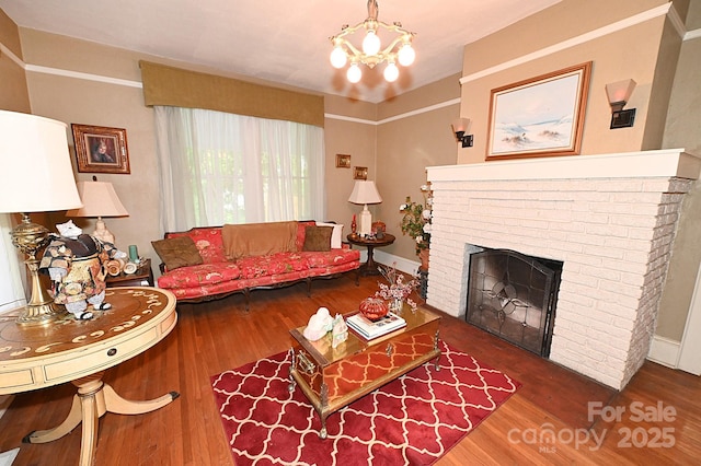 616 N Deal Ave, Newton, NC 28658 - living area featuring wood finished floors, a chandelier, and a fireplace