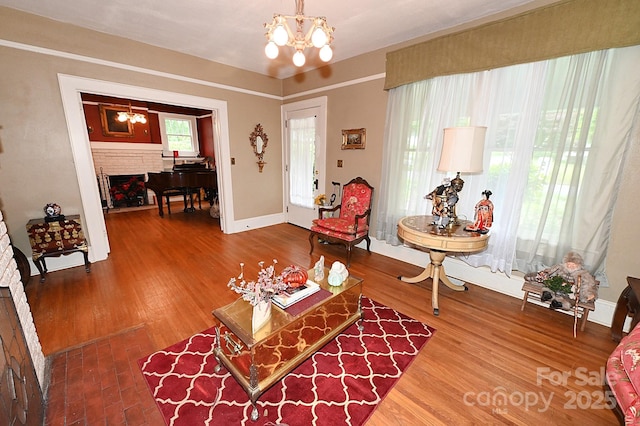 616 N Deal Ave, Newton, NC 28658 - living area with a chandelier, a fireplace, wood finished floors, and baseboards