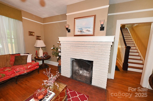 616 N Deal Ave, Newton, NC 28658 - living area featuring a brick fireplace, stairs, baseboards, and wood finished floors