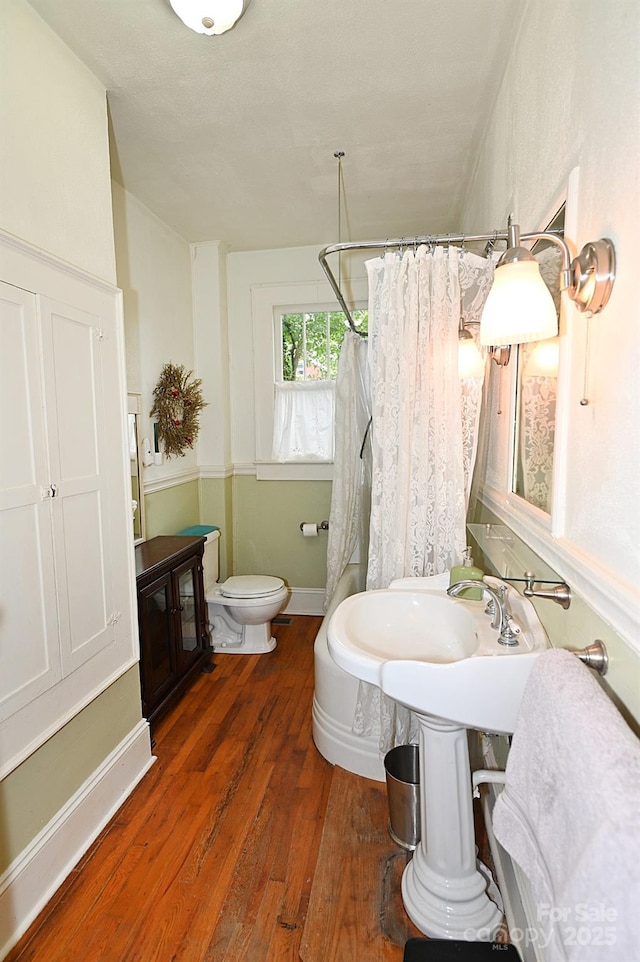 616 N Deal Ave, Newton, NC 28658 - bathroom with toilet, wood finished floors, and curtained shower