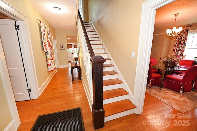 616 N Deal Ave, Newton, NC 28658 - stairway featuring a chandelier, wood finished floors, and baseboards