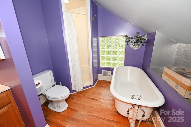 616 N Deal Ave, Newton, NC 28658 - bathroom featuring lofted ceiling, wood finished floors, a freestanding bath, toilet, and baseboards
