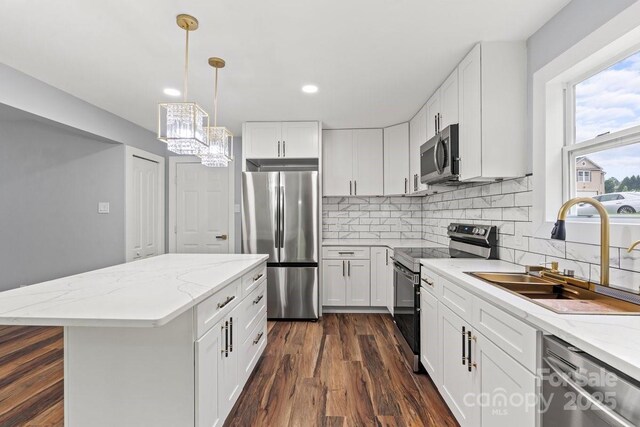 3124 Pikes Peak Dr, Gastonia, NC 28052 - kitchen with appliances with stainless steel finishes, a sink, dark wood-style flooring, decorative backsplash, and recessed lighting