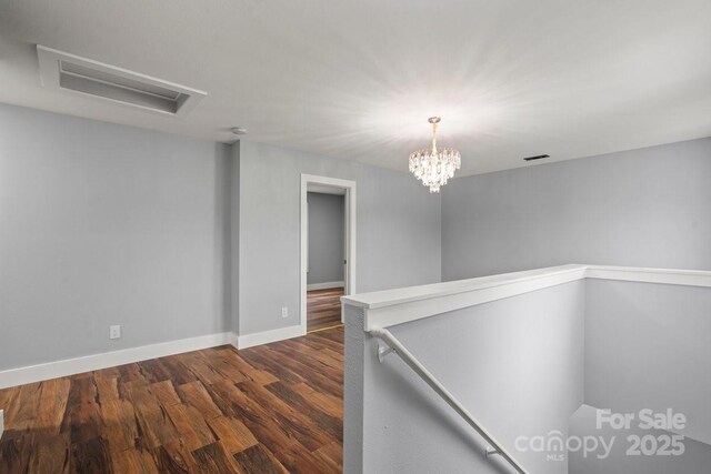 3124 Pikes Peak Dr, Gastonia, NC 28052 - unfurnished room with dark wood-style floors, baseboards, and a chandelier