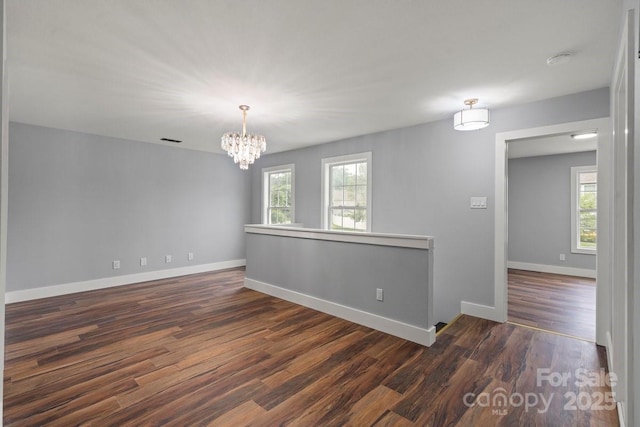 3124 Pikes Peak Dr, Gastonia, NC 28052 - empty room featuring a chandelier, dark wood-style flooring, baseboards, and a smoke detector