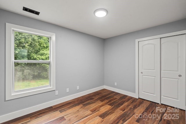 3124 Pikes Peak Dr, Gastonia, NC 28052 - unfurnished bedroom featuring dark wood finished floors, baseboards, and a closet