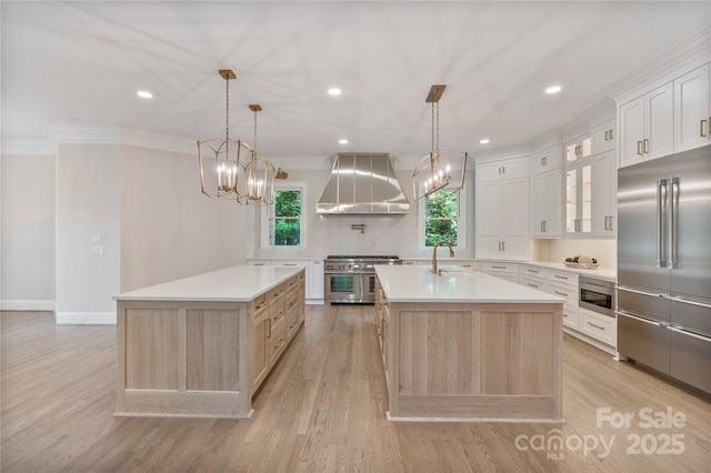 8721 Lake Challis Ln, Charlotte, NC 28226 - kitchen with extractor fan, built in appliances, a center island with sink, tasteful backsplash, and light countertops
