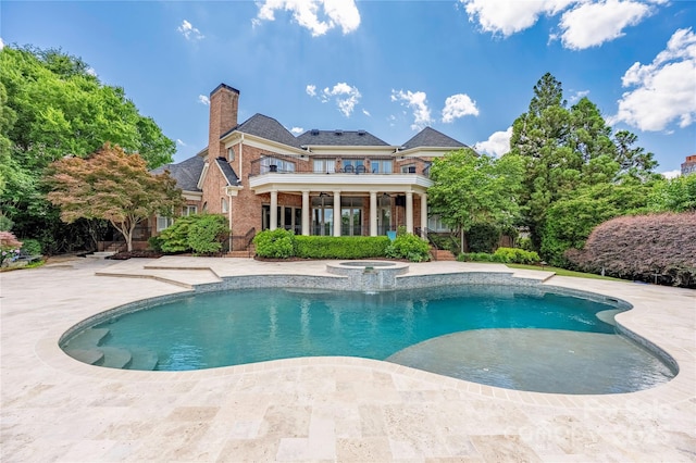 8721 Lake Challis Ln, Charlotte, NC 28226 - back of house with a balcony, brick siding, a chimney, and a patio area