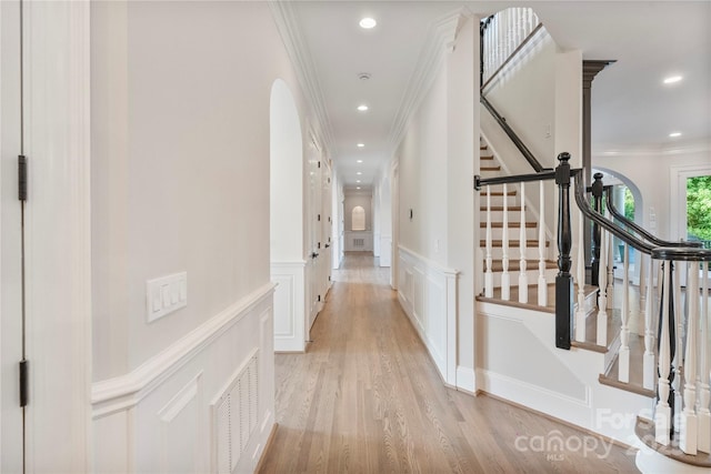 8721 Lake Challis Ln, Charlotte, NC 28226 - corridor featuring ornamental molding, a decorative wall, light wood finished floors, stairway, and a wainscoted wall