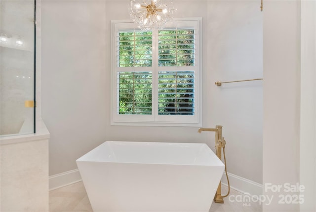 8721 Lake Challis Ln, Charlotte, NC 28226 - full bathroom featuring a freestanding tub and a chandelier