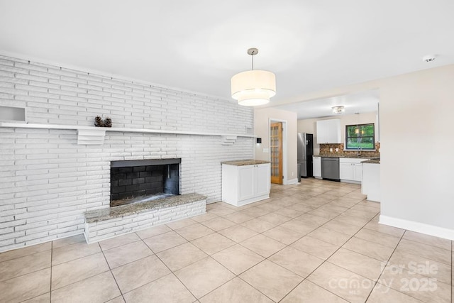 7022 Lakeside Dr, Charlotte, NC 28215 - unfurnished living room with light tile patterned floors, baseboards, and a fireplace
