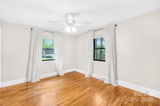 7022 Lakeside Dr, Charlotte, NC 28215 - spare room featuring light wood finished floors, baseboards, and a ceiling fan