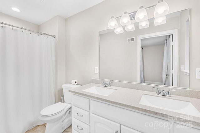 7022 Lakeside Dr, Charlotte, NC 28215 - full bath featuring double vanity, toilet, tile patterned floors, and a shower with shower curtain