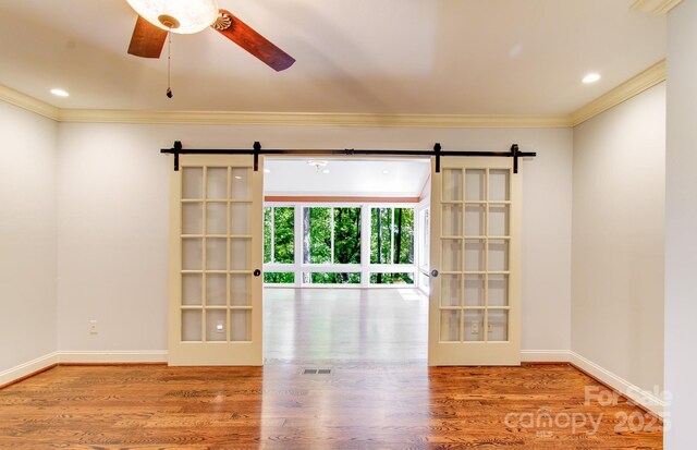 305 E High Point Ln, Hendersonville, NC 28791 - unfurnished room featuring a barn door, crown molding, wood finished floors, a ceiling fan, and recessed lighting