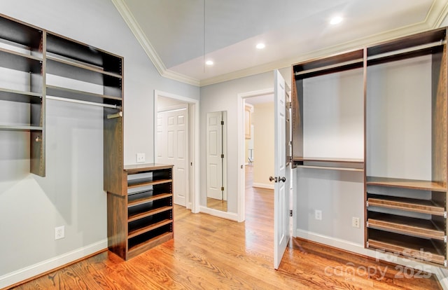 305 E High Point Ln, Hendersonville, NC 28791 - unfurnished bedroom with crown molding, light wood-style floors, vaulted ceiling, a closet, and recessed lighting