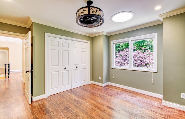 305 E High Point Ln, Hendersonville, NC 28791 - unfurnished bedroom with light wood-style floors, crown molding, baseboards, a closet, and recessed lighting