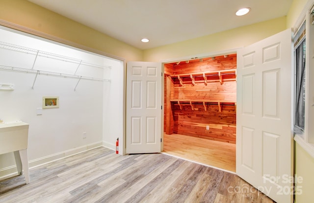 305 E High Point Ln, Hendersonville, NC 28791 - laundry area with wooden walls, light wood-type flooring, hookup for a washing machine, and recessed lighting