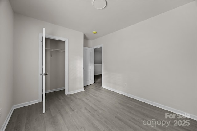 1723 Rhyneland Cir, Gastonia, NC 28054 - unfurnished bedroom with wood finished floors and a closet