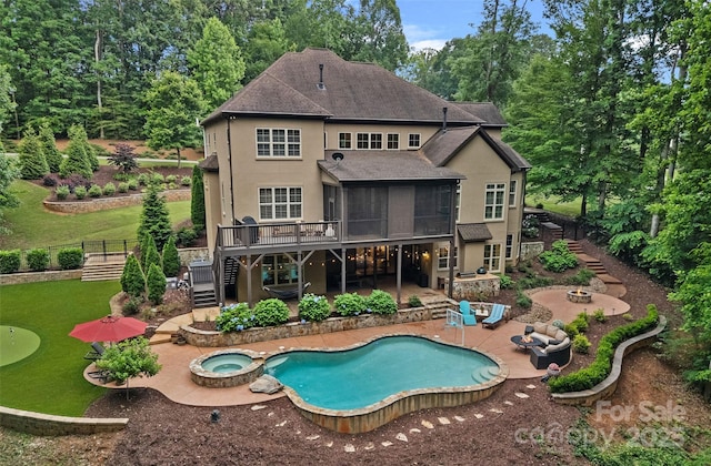 117 Walking Horse Trl, Davidson, NC 28036 - back of property featuring stairway, a sunroom, an in-ground hot tub, stucco siding, and a patio area