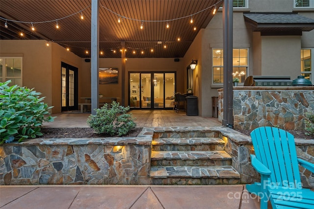 117 Walking Horse Trl, Davidson, NC 28036 - entrance to property with french doors, stucco siding, area for grilling, and roof with shingles