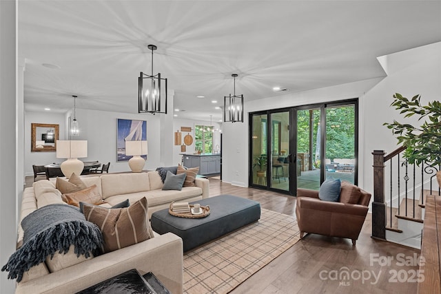 117 Walking Horse Trl, Davidson, NC 28036 - living room with a chandelier, wood finished floors, recessed lighting, healthy amount of natural light, and stairway