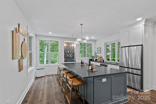 117 Walking Horse Trl, Davidson, NC 28036 - kitchen with freestanding refrigerator, dark countertops, white cabinetry, dark wood-type flooring, and recessed lighting