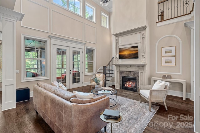 117 Walking Horse Trl, Davidson, NC 28036 - living room with a high ceiling, french doors, dark wood-type flooring, a high end fireplace, and healthy amount of natural light
