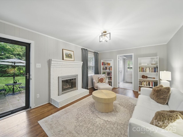 2026 Knell Dr, Charlotte, NC 28212 - living area with plenty of natural light, ornamental molding, a brick fireplace, and wood finished floors
