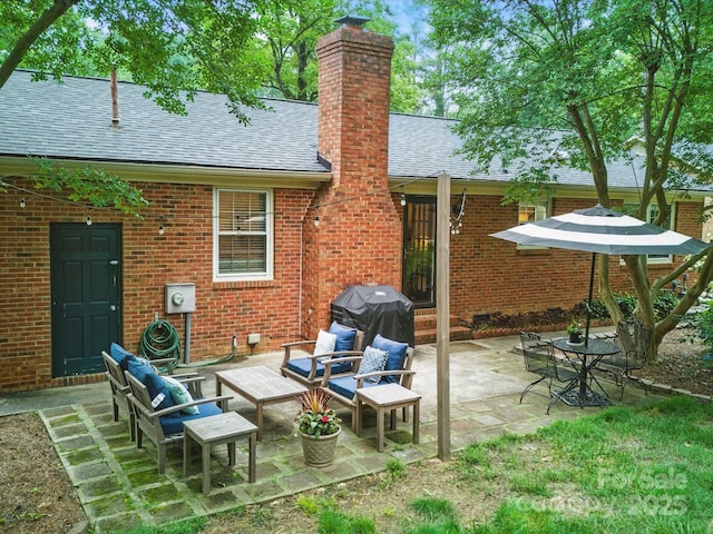 2026 Knell Dr, Charlotte, NC 28212 - rear view of property featuring a shingled roof, brick siding, a chimney, and a patio