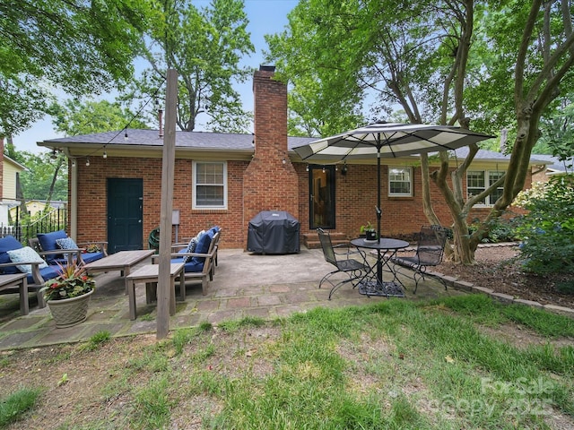 2026 Knell Dr, Charlotte, NC 28212 - rear view of house featuring a patio area, a chimney, and brick siding
