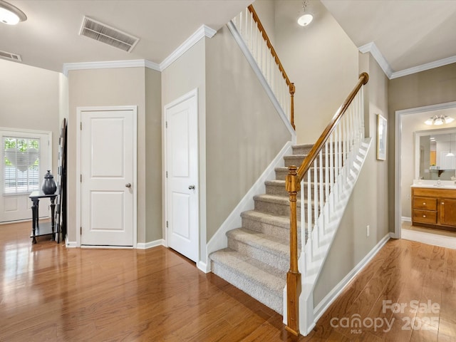 6619 Hermsley Rd, Charlotte, NC 28278 - staircase with wood finished floors, ornamental molding, and baseboards